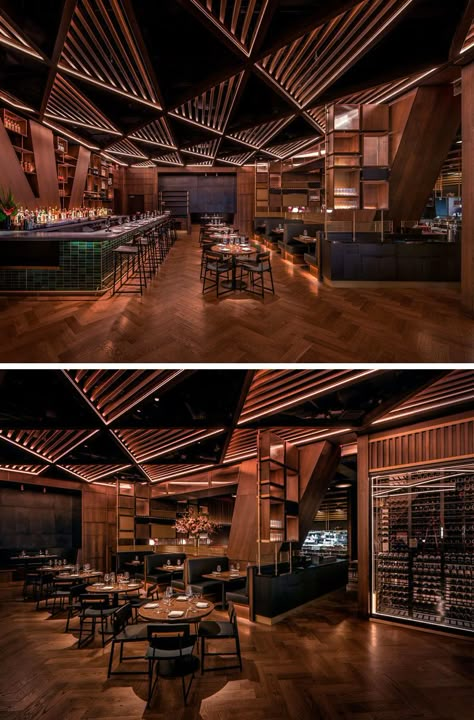 This modern restaurant's distinctive and massive structural joists divide the bar area from the main dining room. These angled columns& inspired the bar’s geometrical millwork and its triangular patterned wood trellis ceiling. #RestaurantDesign #ModernRestaurant #RestaurantInterior Bar Ceiling Lights, Spain Restaurant Interior, Celing Roof Design For Restaurant, Back Bar Design Restaurant Modern, Triangular Ceiling Design, Restaurant Ceiling Design Modern, Bar Ceiling Design, Trellis Ceiling, Restaurant Ceiling Design