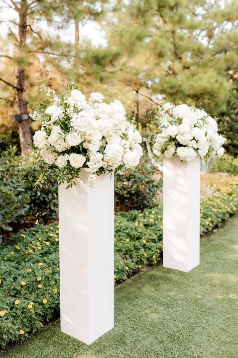 Aisle Pedestal Flowers, Classy Wedding Altar, White Rose Wedding Arrangements, Ceremony Vase Arrangements, White Roses Aisle Decor, Classic Wedding Altar, White Floral Aisle Arrangements, End Of Isle Flowers Wedding, Pillars Wedding Decor Columns