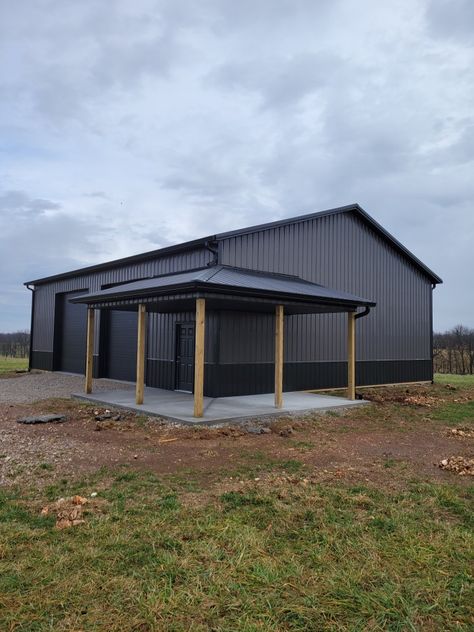 Charcoal Shop Exterior, Shop With Garage Doors, Black Wrap Around Porch, Pole Barn Shop With Porch, Metal Building For Business, Post Frame Garage, Charcoal Grey Metal Building, All Black Metal Building, Black Morton Building