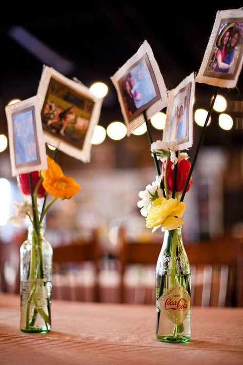 Photos On Sticks Centerpieces, Favors Rehearsal Dinner, Photos Centerpiece Ideas, Photos For Centerpieces, Using Photos As Centerpieces, Photo Vase Centerpiece, Coke Bottle Centerpiece, Diy Wedding Anniversary Decorations, Simple Event Table Decor