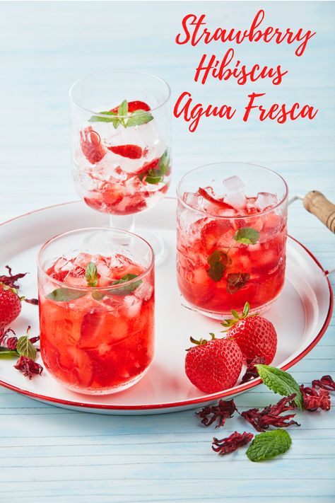 Quench your thirst with this fresh, strawberry hibiscus agua fresca. Aguas frescas or “fresh waters” are non-alcoholic beverages made of fresh fruits. Strawberries and hibiscus are the perfect combination for this refreshing recipe. #californiastrawberries #aguafresca #mocktail #beverage #strawberry #freshwater #infusedwater #nonalcoholicdrinks Auga Frescas, Hibiscus Agua Fresca, Hibiscus Refresher, Summer Fruit Drinks, Fruit Waters, Cool Summer Drinks, Roselle Hibiscus, Strawberry Hibiscus, Fruit Drinks Recipes