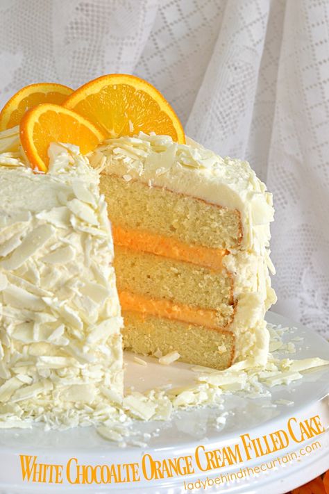 White Chocolate Orange Cream Filled Cake | This wonderfully dense cake has a beautiful colored orange cream filling and white chocolate shavings. A deliciously delightful addition to any Spring or Summer table. Cream Filled Cake, Super Torte, White Chocolate Shavings, Spring Cake, Chocolate Cream Cheese, Orange Cake, Chocolate Shavings, Healthy Smoothie, Easter Cakes