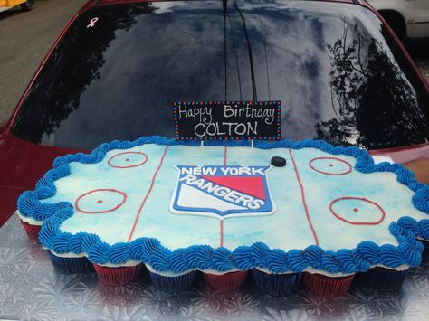 New York Rangers cupcake cake! Hockey Pull Apart Cupcake Cake, New York Rangers Cake, Ny Rangers Cake, New York Rangers Birthday Party, Hockey Cupcake Cake, Hockey Birthday Party Ideas, Hockey Cookies, Hockey Cupcakes, Hockey Cake