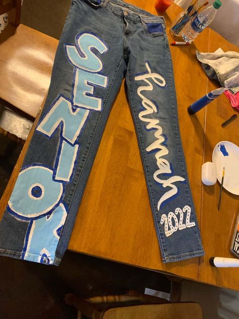 15 Cutest Senior Jeans Ideas We're Obsessing Over Right Now Senior Jeans Ideas, Homecoming Jeans Ideas, Hoco Pants, School Spirit Outfit, Homecoming Jeans, Hoco Jeans, Senior Painted Jeans, Senior Pants, Spirit Jeans