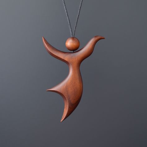 "Romantic pendant \"Dance of Wind\". This handmade wooden pendant is made of stained cherry wood. Pendant is perfectly polished and coated with natural protective varnish. Each jewelry is made by hand and therefore they are unique. Waxed cotton cord with sliding knots. Length adjustable from 16\" to 28\". Pendant is recommended not to wet in water. Please, write us if you have got any question. Materials: cherry wood. Size pendant:  height  2,4 inches (60mm)  width  1,8 inches (45mm)  depth  0,3 inches (8mm) Thank you for visiting our shop." Wooden Jewelry Handmade, Wood Necklace Pendant, Simple Wood Carving, Wood Jewelery, Wood Art Projects, Romantic Necklace, Necklace Wood, Diy Wooden Projects, Wood Carving Designs