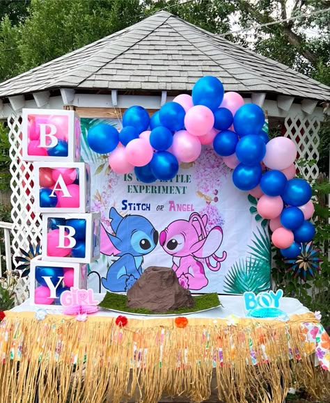 a stitch & angel themed banner is hung behind a table with a DIY volcano placed on top of it. there is a pink & blue balloon arch above the banner & on the sides of the volcano it says “boy, girl”. the table has a table skirt on it & there are boxes on the left side that say “baby”. Lilo Gender Reveal, Stitch Themed Gender Reveal Ideas, Gender Reveal Ideas Hawaiian, Gender Reveal Ideas Cartoon, Lilo And Angel Gender Reveal Ideas, Gender Reveal Ideas Cartoon Theme, Cartoon Theme Gender Reveal, Creative Gender Reveal Themes, Kilo And Stitch Gender Reveal