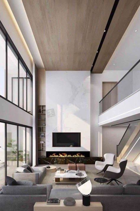 We're obsessed with this living room design. It has unique details and the perfect statement pieces! Find out the Best Interior Designers in New York City in the link below! #newyorkfurniture #newyorkart #newyorkarchitecture #newyorkproperty #newyorkdesigner Double Height Fireplace Modern, Wood Accent Wall High Ceiling, Double Volume Living, High Ceiling Tv Wall Interior Design, Modern Fireplace High Ceiling, Double Height Living Room Fireplace, Fireplace Double Height, Double Volume Ceiling Design, Tv Wall Double Height