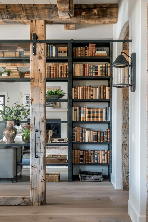 Elegant rustic farmhouse library corner featuring weathered wood beams and a rich collection of books on black shelves, adding cozy charm. #FarmhouseWallDecor Rustic Floor To Ceiling Shelves, Rustic Library Room Ideas, Minimalist Modern Farmhouse Living Room, Reclaimed Wood Built Ins, Rustic Shelves Living Room, Rustic Wood Book Shelves, Rustic Wall Book Shelf, Library Wall In Living Room, Modern Library Room