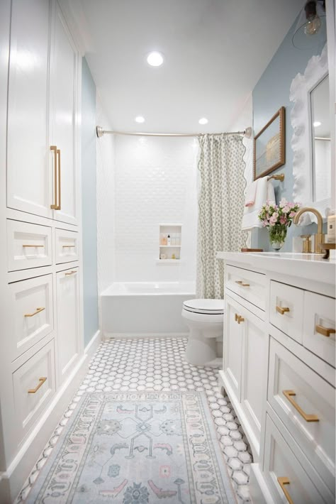 White Walls With Gold Accents, Bathroom With Blue Bathtub, Hardwoods In Master Bath, Bathroom Decor Remodel, Blue Striped Bathroom, White Gold Blue Bathroom, Amalfi Coast Inspired Bathroom, Ballard Designs Bathroom, Coastal Traditional Bathroom