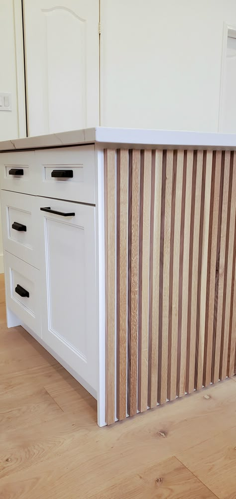 Wood Accent Island Kitchen, Wooden Slat Backsplash, Kitchen Island With Paneling, Pole Wrapped Kitchen Island, Slatted Kitchen Cabinets, Kitchen Island Slats, Fluted Wood Island, White Island Wood Cabinets, Kitchen Island Pole Wrap