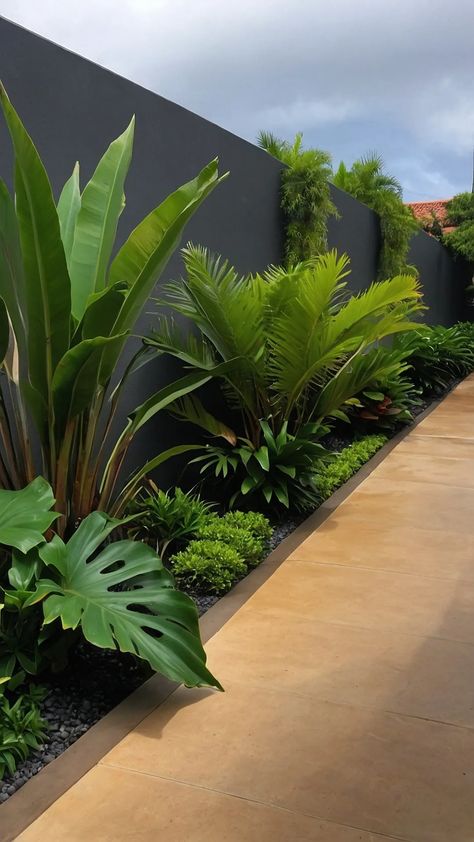 Revamp Your Garden: 15 Tropical Landscaping Ideas You’ll Love - pulsepathlife.com Interior Design Garden Outdoors, Bird Of Paradise Plant Landscape, Beautiful Plants For Garden, Tropical Modern Landscaping, Tropical Fence Landscaping, Florida Landscaping Ideas Backyard Pool, Pool Plants Ideas, Home Garden Landscape Design, Caribbean Garden Ideas