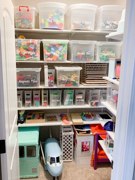 Toy storage closet in a playroom. We used Ikea Boaxel shelving to transform this storage closet. Now that we can better utilize all that vertical space and make this storage closet truly function well for this family. I love the vinyl custom labels that were made and the multipurpose bins from the container store. Small Playroom Organization, Playroom Organizing, Small Kids Playrooms, Storage Playroom, Toy Cupboard, Playroom Closet, Toy Room Organization, Playroom Inspiration, Small Playroom