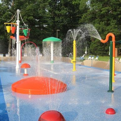 Thinking about making your facility more family friendly for the summer? Try incorporating a splash pad! A splash pad is a great addition to any facility looking to be more competitive with other summer attractions. #americanpool #pools #splashpad #summerattractions #familyfun #poolrenovations #summerfun #activitiesforkids #spraypads #waterplay Water Park Ideas, Backyard Splash Pad, Backyard Water Parks, Park Ideas, Play Structures, Water Playground, Playground Ideas, Splash Park, Children Park