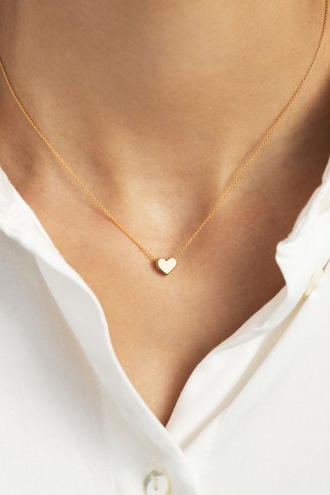 This petite gold heart pendant necklace will compliment everything from denim to little black dresses. Designed with both comfort and style in mind, this piece is perfect for everyday wear. Minimalist with a high shine finish, this small yet mighty stunner is bound to become a staple in any gal’s ensemble. Gift this symbolic piece to a loved one or better yet, gift it to yourself! Small Heart Necklace, Tiny Heart Necklace, Heart Choker Necklace, Aventurine Necklace, Double Heart Necklace, Heart Choker, Heart Pendant Gold, Jewelry Design Earrings, Diamond Cross Pendants