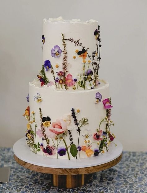 White Cake With Colorful Flowers, Wedding Cakes With Wild Flowers, Meadow Wedding Cake, Wildflower Bridal Shower Cake, Wildflower Wedding Theme Cake, Wild Flower Theme Wedding, Wild Flowers Wedding Cake, Wild Flower Engagement Party, Purple Green Wedding Cake