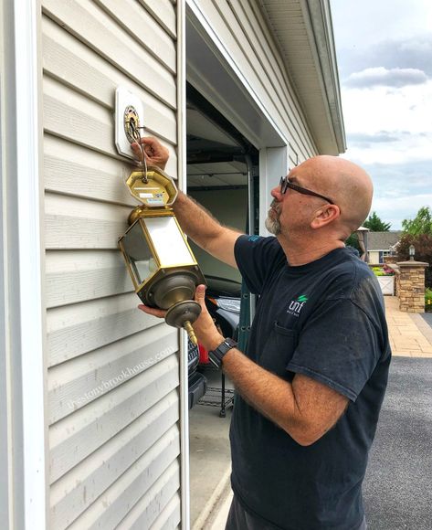 Hubby taking off outdoor light fixture Barn Lights Exterior, Outside Light Fixtures, Outdoor Garage Lights, Outdoor Light Fixture, Outdoor Porch Lights, Outside Light, Painting Shutters, Front Door Makeover, Orange Door