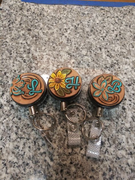 Leather Badge Reel, Tooled Leather Badge Reel, Tooled Leather Christmas Ornaments, Tooled Leather Projects, Western Boutique Ideas, Leather Keychain Ideas, Makeup Boxes, Handmade Leather Work, Nurse Things