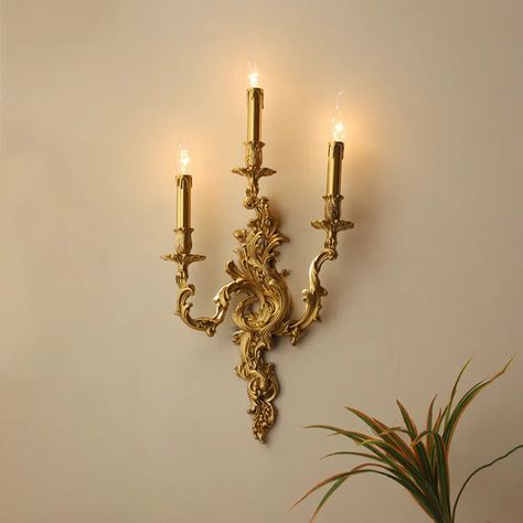 Introducing the Afralia™ Antique Brass Wall Sconces, a timeless piece that combines vintage charm with a touch of royal elegance. Crafted with exquisite attention to detail, these French-inspired wall lamps exude a sense of sophistication and luxury, making them the perfect addition to any space. Illuminate your surroundings with the warm glow of LED bulbs, creating a welcoming ambiance in your kitchen, dining room, bedroom, foyer, study, or corridor. The classical design, featuring up & down sh Vintage Wall Lights Living Room, Wall Antique Decor, Antique French Interior Design, Antique Gold Light Fixtures, Vintage Lights Aesthetic, Antique Brass Chandelier Vintage, Antique Wall Lamp, Indoor Wall Sconces Living Room, French Rococo Decor