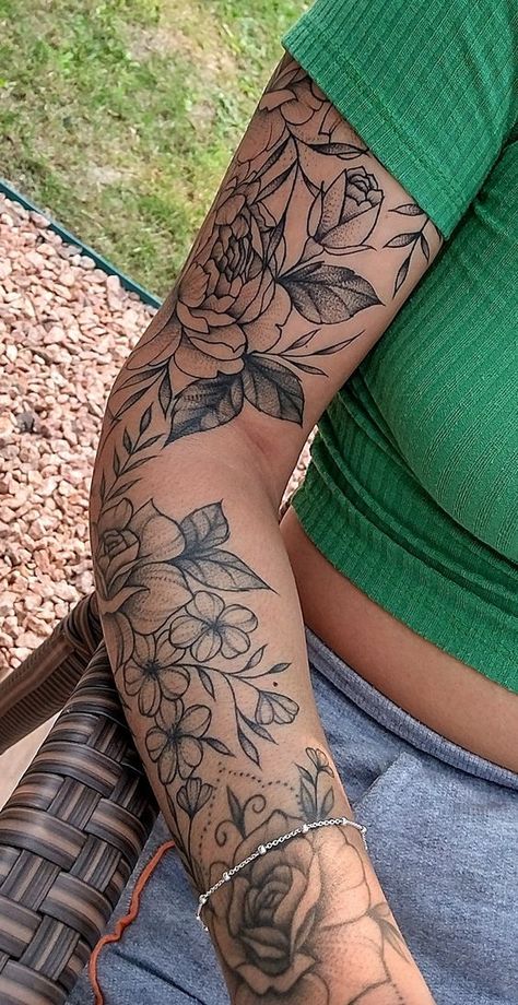 9998 Close-up of a woman's arm with detailed floral tattoo, wearing a green top and gray pants, sitting outdoors on a wicker chair. | Sky Rye Design Arm Sleeve Tattoos For Women, Tattoo Leg, Floral Tattoo Sleeve, Forearm Tattoo Women, Flower Tattoo Sleeve, Leg Tattoos Women, Pretty Tattoos For Women, Feminine Tattoo, Arrow Tattoo