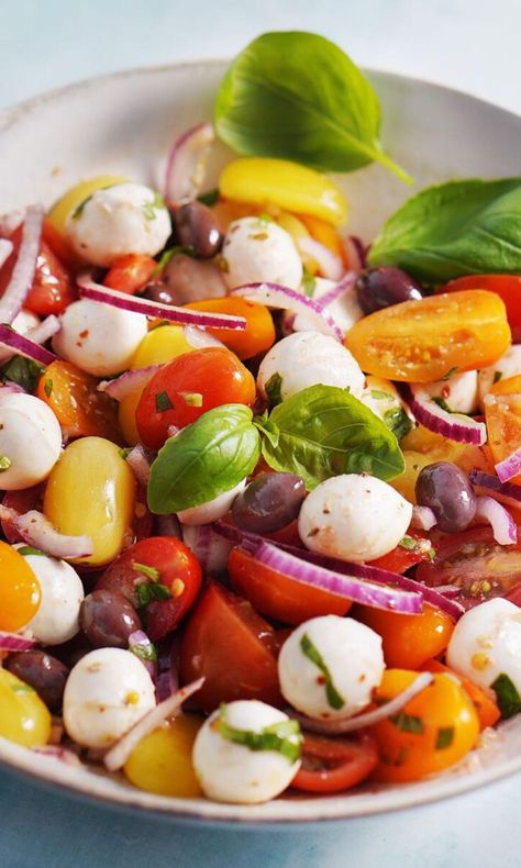 Tomato & Mozzarella Salad. This dish of marinated cherry tomatoes, olives, and mozzarella is super simple but oh so delicious, especially when cherry tomatoes are in season. Pearl Mozzarella And Tomato, Tomato Basil And Mozzarella Salad, Pearl Mozzarella Recipes, Tomato Basil Mozzarella Salad, Cherry Tomatoes Recipes Salad, Mozzarella Tomato Salad, Marinated Cherry Tomatoes, Tomato Basil Salad, Tomato Mozzarella Salad