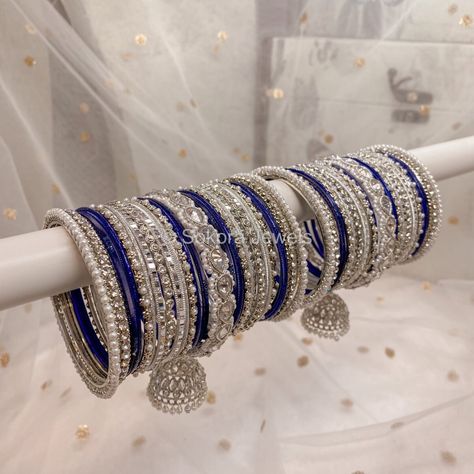 Large stack of luxurious Silver & clear stonework bangles with Navy blue shades finished with our Chunky Silver Husna Jhumka bangles. This will make the perfect stack for any Bride or those wanting to make a statement. Pair this with our Aafiya Bridal Set - Navy Sold as a set for both arms only. Ready to Ship! Navy Blue Bangles Set, Blue Bangles Set, Jhumka Bangles, Bridal Bangle Set, Silver Jewelry Indian, Blue Bangles, Navy Blue Jewelry, Silver Indian Jewelry, Blue Jewelry Set