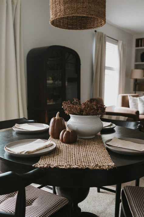 Black Round Dining Room Table Decor, Dining Room With Black Round Table, How To Style Round Table, Black Round Table Dining Room, Circle Dining Table Decor Centerpiece, Every Day Dining Room Table Decor, Black Circle Table Dining Rooms, Black Round Table And Chairs, Dark Kitchen Table Decor