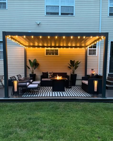 Donice (Dah-neece) on Instagram: "Home lately 🖤  It’s cozy, summer nights on the patio season 🖤  Louvered Pergola @miradoroutdoor  Indoor/outdoor rug @jonathany_official  String lights @jonathany_official   #patio #patioseason #pationights #patiolights #patiodesign #pergoladesign #louveredpergola #louveredroof #louveredpergolas #patiorugs #patiorug #blackpatio #blackpatiodecor #patiostringlights #pergolas #patioinspo #patioinspiration #patioliving #patiolife #modernpatio" Patio Deck With Pergola, All Season Pergola, Ideas Pergolas Jardin, Pergola Lights String Ideas, Simple Deck Ideas, Outdoor Pergola Ideas, Backyard Pergola Ideas, Patio Roof Ideas, Patio Shade Ideas