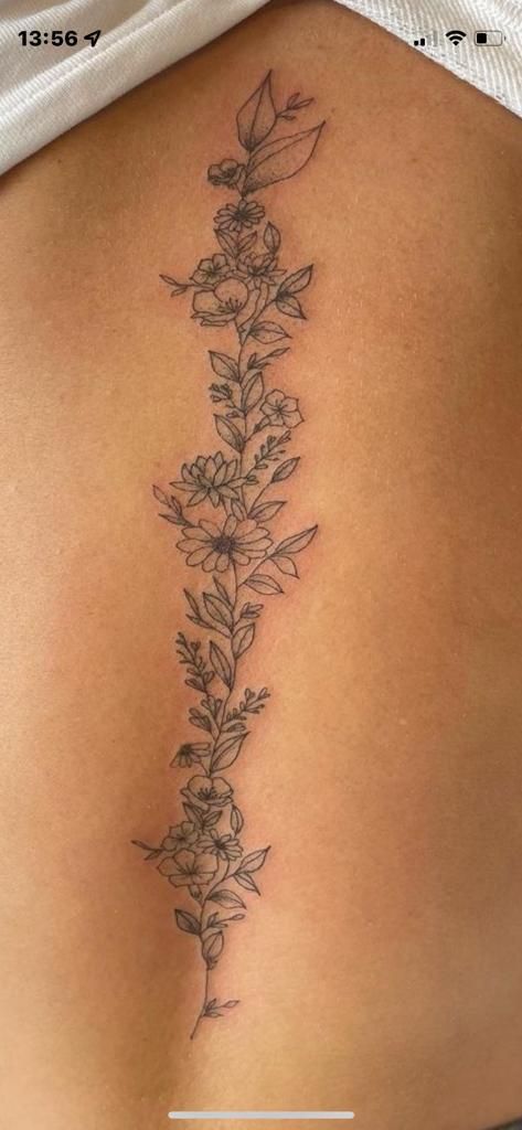 Flower Tattoos Down Spine, Flowers And Vines Spine Tattoo, Flower Tattoos Back Spine, Spin Flower Tattoos For Women, Flower Vine Tattoos Spine, Daisy And Vine Tattoo, Flower Down Spine Tattoo, Spine Tattoos Wildflower, Larkspur Flower Tattoo Spine