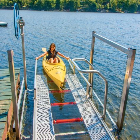 If your water levels fluctuate, our launch port lift has a lifting height of 75" so you can easily launch your kayak, canoe or other small craft from your dock. Easily raise and lower the launch platform with the 30" handwheel, board your craft with the assistance of the boarding handle, then smoothly launch your boat from the launch ramp with non-marring Stoltz polyurethane rollers and grab & launch rails.  Launch ramp features non-skid Sure-Step® vinyl decking on the platform. Kayak Launch Ramp, Docks On The Lake Ideas, Boat Deck Ideas, Dock Ideas Lakeside, Kayak Ramp, Kayak Dock, River Dock, Kayak Pictures, Vinyl Decking