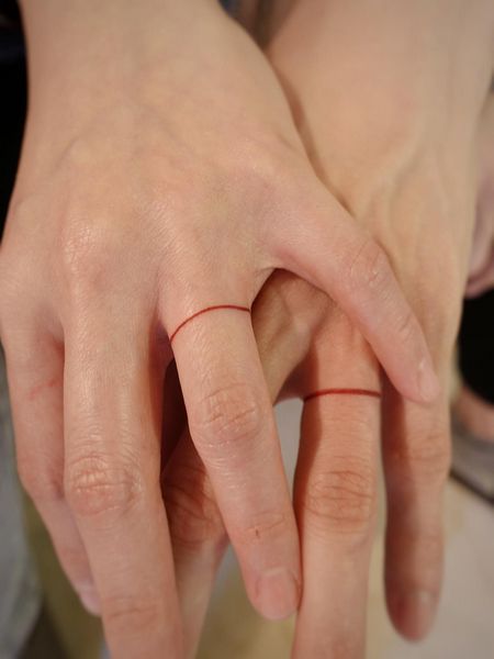 Promise Ring Tattoo Couple, Matching Wedding Tattoo Ideas, Red String Finger Tattoo, Man Ring Tattoo, Ring Tattoo Couple, Red String Ring, Red String Tattoo Couple, Couple Ring Tattoos Marriage, Red Knot Tattoo