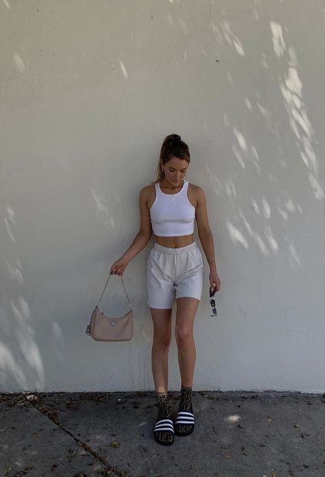 white halter tank top paired with grey or gray sweatshorts long socks and sandals or slide and a purse and sunglasses #accessories #purse #glasses #ponytail #lazy #chill laidback outfit. ponytail hairstyles.  Pink prada purse Gray Sweatshorts Outfit, Outfits With Sweatshorts, Sweatshorts Outfits, Grey Shorts Outfit, White Shorts Outfit, Slides Outfit, Shorts Outfits Women, Model Outfit, Thrifted Outfits