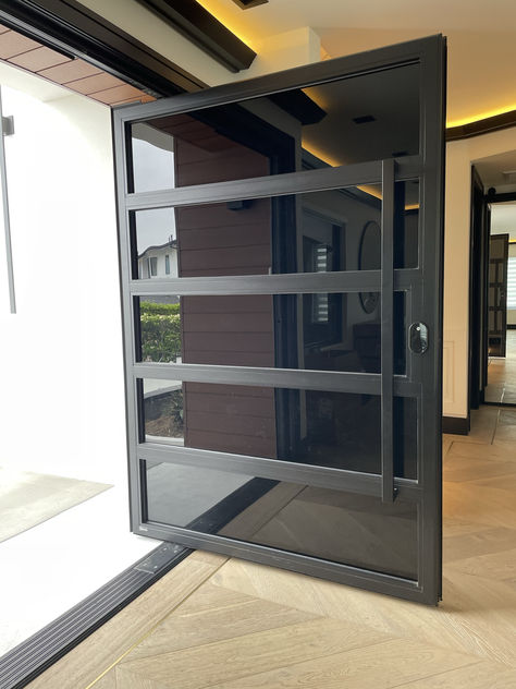 Custom aluminum and glass pivot door. Steel Door Design Front Entry, Aluminum Entrance Door, Aluminium Doors Entrance, Pivot Doors Entry Modern, Entry Doors Modern, Modern Glass Pivot Front Door, Aluminum Glass Door, Pivot Doors Entry, Pivot Metal Door