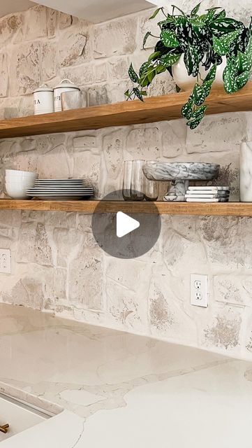 Kelsey Gibby on Instagram: "I’ve always loved the look of stone backsplash in a kitchen but actually seeing it in person and installing it has taken that to a whole different level. Not to mention Karleys selections with it couldn’t have been any more perfect. Really enjoyed tackling this DIY project with one of my friends. Can’t wait to see how the rest of her house turns out!   Stay tuned this week for a full tutorial of the stone installation and floating shelves." Kitchen Backsplash Stone Tile, Stone Wall With Floating Shelves, Stone Wall Backsplash Kitchen, Stone Backsplash Behind Stove, White Cabinets With Stone Backsplash, Fieldstone Backsplash, Stove Niche Ideas, Rock Kitchen Wall, Rock Wall In Kitchen