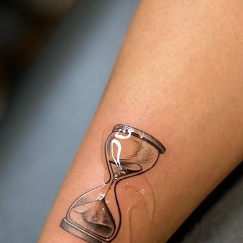 R’ink Tattooz - Tattoo studio, Delhi on Instagram: "Passage of Time: At its core, an hourglass symbolizes the relentless and impartial march of time. The grains of sand slipping from one bulb to another remind us of the fleeting nature of life, urging us to make the most of each precious moment. Hour glass tattoo . For tattoo appointment / queries  📩 @rinktattooz  ☎️ +91 96670 20423 📍 E-13, 2nd floor, South extension II main market, New Delhi  . . #hourglasstattoo #passageoftimetattoo #mortalitytattoo #balancetattoo #patiencetattoo #reflectiontattoo #remembrancetattoo #timetattoo #lifetimetattoo #transformation #steadfasttattoo #philoshopicaltattoo #depttattoo #tattoo #lifebeautytattoo #lifegoal #explore #art #design #ink #tattoodesign #smalltattoo #finelinetattoo #neatlinetattoo #easthe Sand Dial Tattoo, Cracked Glass Tattoo, Sands Of Time Tattoo, Hourglass Tattoo Simple, Time Is Precious Tattoo, Hourglass Tattoo Men, Sand Timer Tattoo, Sand Clock Tattoo, Relentless Tattoo