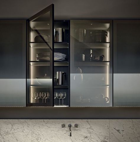 a kitchen cabinet with smoke glass doors shows off the glasses and dishes but gently Kitchen Minimal, Glass Kitchen Cabinet, Glasses Kitchen, Black Modern Kitchen, Glass Kitchen Cabinet Doors, Glam Kitchen, Minimal Kitchen, Kitchen Glass, Interior Minimalista