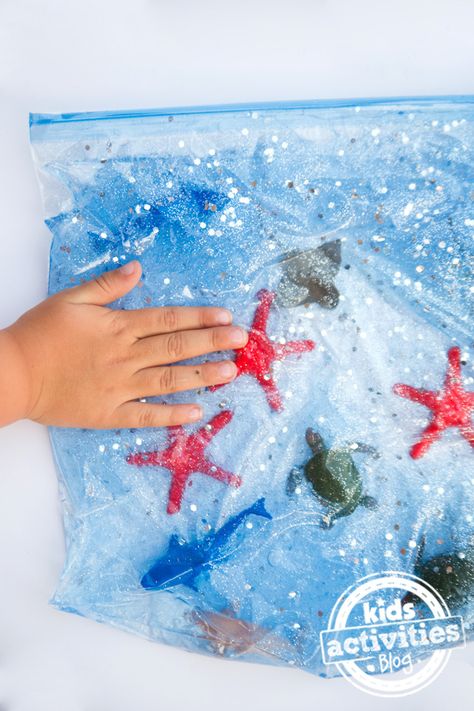 Fish Art For Infants, Under The Sea Sensory Activities, Sensory Ocean Activities, Ocean Sensory Bags, Under The Sea Messy Play, Ocean Dramatic Play Preschool, Ocean Craft Preschool, Water Animals Activities For Kids, Ocean Sensory Table