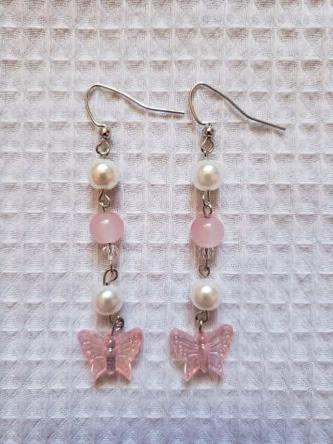 Handmade earrings inspired by candy and butterflies ♡ Materials: ♡ pink butterfly and round beads ♡ faux pearls ♡ mini pink beads ♡ silver and jewelry wire How To Make Cute Earrings, Pink Bead Earrings, Handmade Pink Butterfly Earrings, Trendy Pink Butterfly Earrings, Pink Butterfly Charm Earrings, Pink Butterfly Charm Drop Earrings, Pink Butterfly Charm Earrings For Gift, Pink Butterfly Charm Earrings As Gift, Pink Drop Earrings With Butterfly Charm