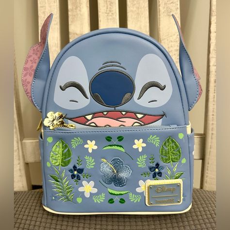 Add Some Floral Fun To Your Disney Parks Look With This Lilo & Stitch Mini Backpack! Featuring Embroidered Details Of Stitch's Face On The Body, The Front Pocket Includes Embroidered Flower And Leaf Designs. With 3d Ears And A Flower Zipper Pull, This Bag Is Made For Beach Days. Don't Forget The Matching Coin Purse That I Have Listed Separately! Approx. 10 1/2" H X 7 1/2" W X 5" D Stitch Backpack, Stitch Stuff, Loungefly Bag, Leaf Designs, Toy Food, Loungefly Disney, Lilo Stitch, Disney Lilo, Embroidered Details