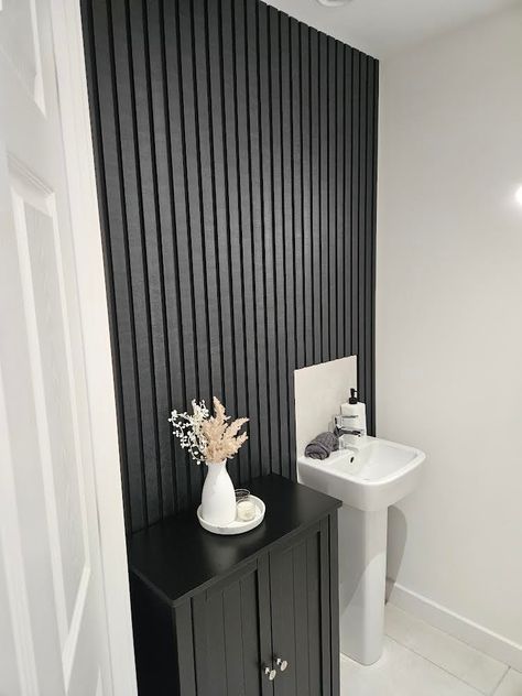 This Slate Black slatted wall panel from Volga Panels with a slate stone effect surface is a versatile decorative wall panel that can transform the look of any walls or surfaces. They are waterproof, moisture-proof, weather-proof and is virtually maintenance free. Volga Panels are produced specifically to ensure an easy DIY install. Volga Panels can be used in bedrooms, living rooms bathrooms, kitchens, exteriors and more. Fully Waterproof Fully Moisture-proof Fully Weatherproof The dimensions o Wooden Slat Wall Interiors Bathroom, Black Panel Bathroom, Bathroom Wood Panel Wall, Half Wall Black Paneling, Accent Design Wall, Pole Wrap Wall Bathroom, Fluted Wall Bathroom, Modern Shiplap Bathroom, Bathroom Panelling Waterproof