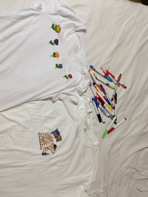 Two white t shirts drawn on with fabric markers one has flowers one has a bear Fabric Marker Shirt, Fabric Markers Diy T Shirts, Fabric Marker Ideas, Marker Ideas, Its Raining, Diy Marker, Fabric Markers, Diy Shirt, T Shirt Diy