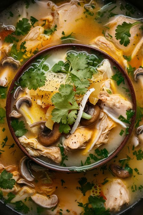 A bowl of chicken soup with mushrooms, cilantro, and spices. Lemongrass Soup Recipe, Galangal Recipe, Lemongrass Soup Thai, Thai Lemongrass Soup, Tom Kha Gai Soup Recipe, Thai Soups, Thai Coconut Curry Soup, Thai Soup Recipes, Tom Kha Gai Soup