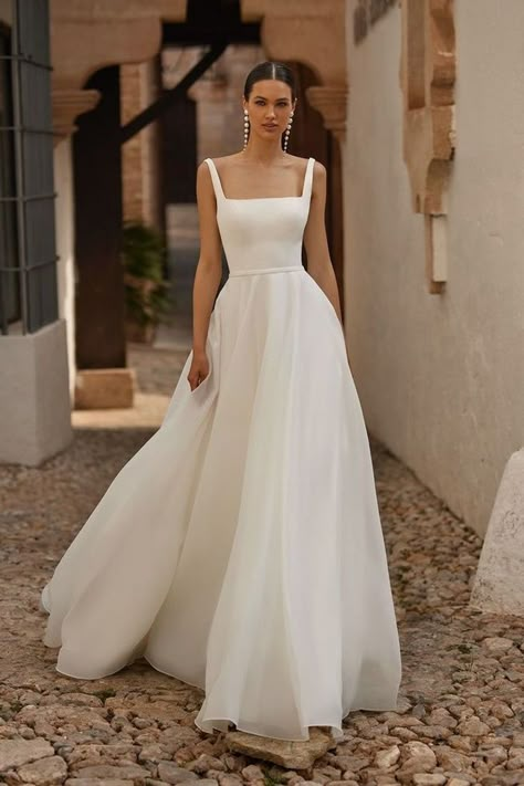 Discover the breathtaking Moonlight Bridal T133, designed for the discerning minimalist bride. This A-line gown boasts a figure-flattering silhouette and a chic square neckline. The satin bodice is complemented by a soft organza skirt that adds an element of romance. Wide straps add a modern touch that perfectly complements this timeless design. #weddingdressinspo #bridalfashion #modernweddingdress Simple Wedding A Line Dress, Chiffon Wedding Dress A Line, Simple Wedding Dress White, Wedding Dress Chiffon Skirt, Simple Soft Wedding Dress, Bride Dress Minimalist, Satin Bodice Tulle Skirt Wedding Dress, Figure Flattering Wedding Dresses, Wedding Dress For 5ft Bride