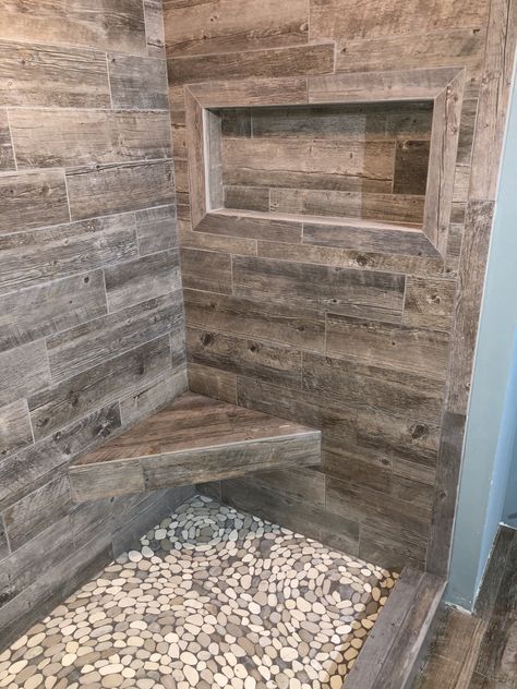 Plank tile shower walls. River rock pebble shower pan. W.R. Jones Tile & Stone West Bend WI. #westbendtile #wrjonestilestone #wisconsintile Rock Shower Floor, تصميم دورة مياه, Rustic Bathroom Shower, Rock Shower, Makeover Kamar Mandi, Cabin Bathrooms, Rustic Bathroom Designs, Shower Walls, Rustic Bathrooms