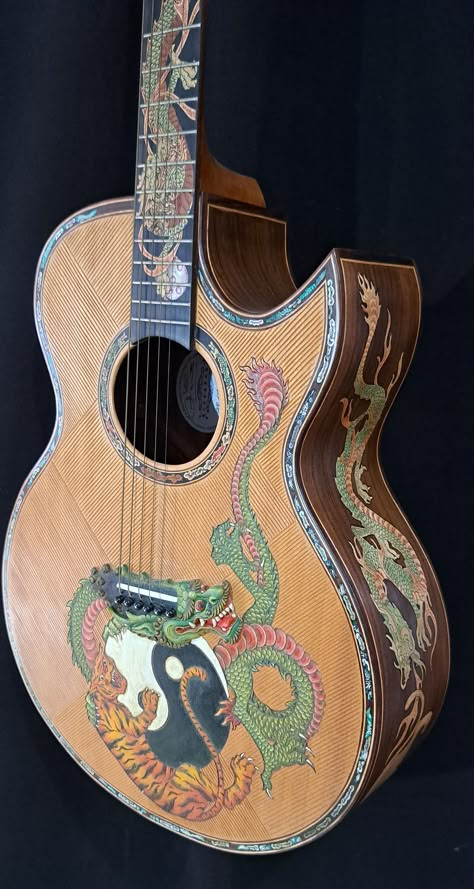 Blueberry NEW IN STOCK Handmade Acoustic Guitar Grand Concert Dragons & Tigers Watch and listen to a Blueberry Grand Concert Guitar in Action https://youtu.be/D_A5TUK-djE Blueberry Handmade Acoustic Guitars are made on the tropical island of Bali by our experienced team of traditional wood carvers and artisans who have been practicing their craft for generations.   Our unique workshop has been creating singular objects of musical and visual beauty since 2005.   This is your opportunity to own a Custom Painted Guitar, Cool Acoustic Guitars, Art On Guitar, Acoustic Guitar Art, Baritone Guitar, Guitar Obsession, Guitar Painting, Wood Carver, Of Montreal