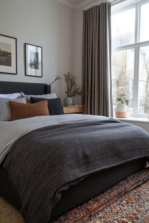 Create a romantic, neutral bedroom with these tips on how to style a gray bedroom. Grey Headboard Brown Furniture, Bedding With Dark Sheets, Grey Vintage Bedroom, Dark Grey Fabric Headboard Bedroom Ideas, Black Gray Tan Bedroom, Bedding With Dark Grey Headboard, Dark Grey Bed Decor, Grey Backboard Bedroom, Grey Bed Frame Bedding