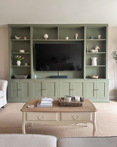 Happy Sunday! This is my current view as I sit with a cup of tea, a good book and a very sleepy puppy ☺️☕️ I get lots of questions about the media unit in the living room - we had the unit built bespoke by a local carpenter and then painted it in F&B Treron (colour matched with Brewer’s paint) 💚 The cupboard handles are from @ah_brass and our tv size is 65’ I’m so glad I went with the bold colour! It’s the focal point of the room and I love it 🥰 . . #mediaunit #mediawall #mediawalldesi... Coloured Cabinets Living Room, Fitted Cabinets Living Room, Media Units Living Room, Living Room Built Ins With Tv, Lounge Cupboards, Media Unit Living Room, Tv Unit Ideas Living Room, Built In Cupboards Living Room, Living Room Built In Cabinets