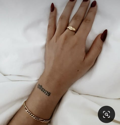 Strength Wrist Tattoo, Word On Wrist Tattoo, Word Strength Tattoo, Strength Word Tattoo, Tattoo Name On Wrist, Strength Tatoos Woman, Upper Wrist Tattoos For Women, Wrist Word Tattoos For Women, Word Tattoo Wrist