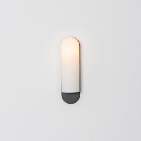 Odyssey lg sconce by schwung dimensions: w 10.5 x d 14 x h 38 cm materials: brass, frosted glass finishes available: black gunmetal, polished nickel, brass schwung is a german word, and loosely defined, means energy or momentumm of a positive manner. Synonyms: verve, zest, panache, momentum. Mission developing lighting fixtures through simple and timeless materials, sustainably; we are committed to creating quality products that last. Beginning with the design we are constantly refining aestheti German Word, Black Sconces, Black Wall Lights, Modern Baths, Lighting Design Interior, Outdoor Sconces, Wild Rice, Black Wall, Light Sconces