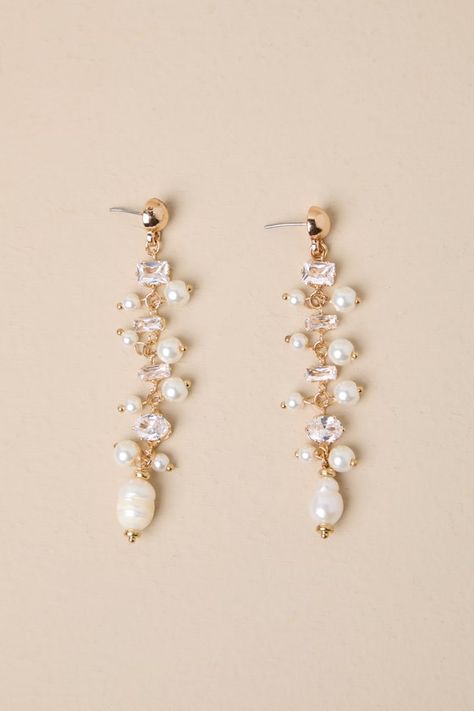 If you have an instinct for elegance, you need the Lulus Decadent Approach Gold Pearl Rhinestone Drop Earrings! Shiny, gold-toned metal shapes these stunning earrings that have a drop silhouette with various sizes and cuts of rhinestones (along with luminous faux pearls) strung across their length. Post backs. 3" Long. 40% Iron, 40% Plastic, 20% Pearl. Imported. Lulus | Decadent Approach Gold Pearl Rhinestone Drop Earrings. Light Yellow Earrings, Opal Wedding Earrings, Hoco Earrings, Hoco Jewelry, Pearl Dangle Earrings Wedding, Wedding Earrings Bride, Pearl Wedding Accessories, Hoco Inspo, Rose Gold Bridal Jewelry