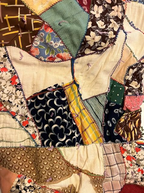 Close up of another vintage crazy quilt made from silks; Crazy quilts have asymmetrical designs, vibrant colors, and intricate stitching patterns. Originating in the late 19th century as a rebellion against the rigid rules of traditional quilting, this unique art form allows quilters to unleash their imagination and showcase their individuality through a patchwork of fabrics. Vintage Crazy Quilts, How To Sew A Crazy Quilt, How To Make A Crazy Quilt, Crazy Quilts Patterns Templates, Scrappy Patchwork Quilts, Scrap Quilts Ideas, Crazy Quilt Patterns, Unique Quilt Patterns, Crazy Quilt Templates